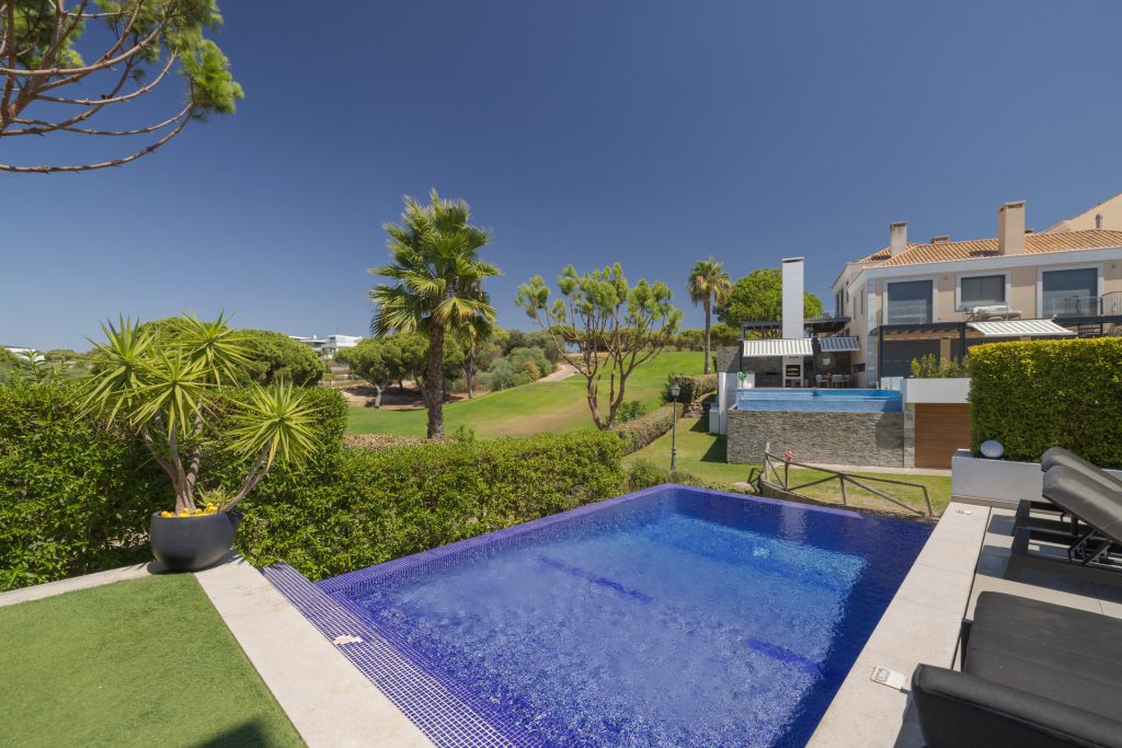 Poolside relaxation area with shaded seating