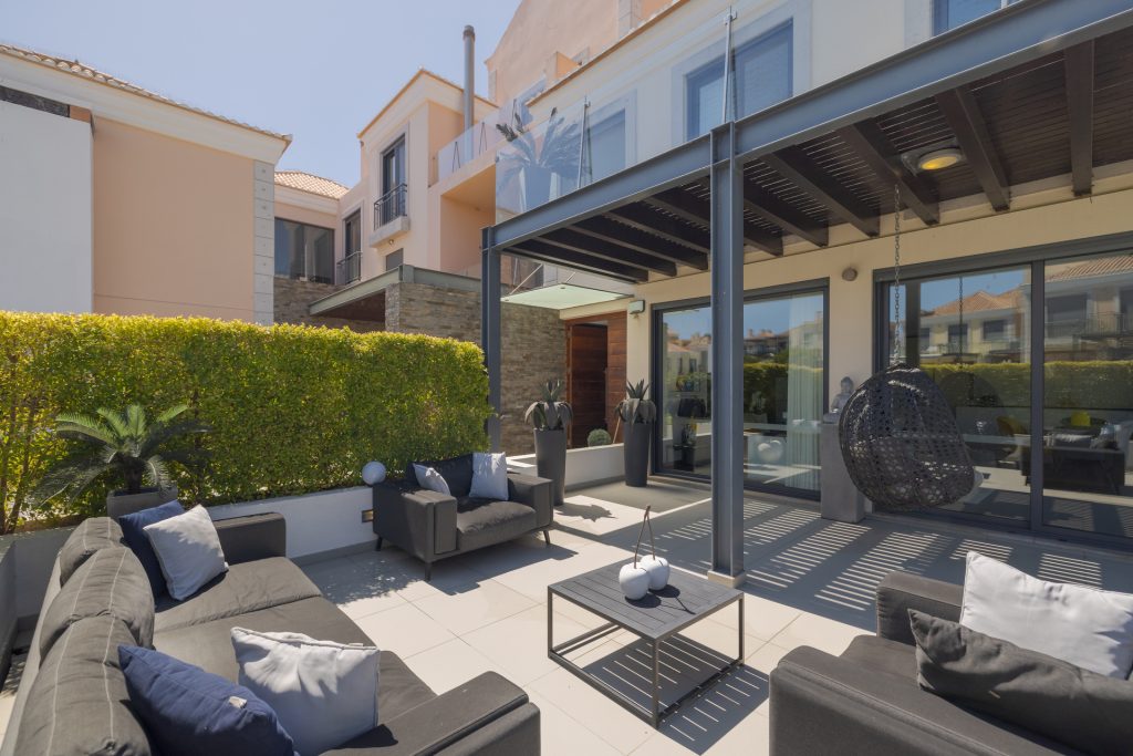 Comfortable outdoor lounge area with cushioned sofas by the private pool