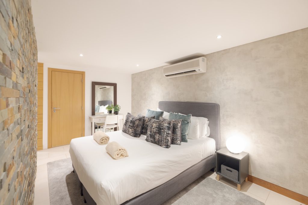 Lower ground floor bedroom featuring a double bed and modern decor