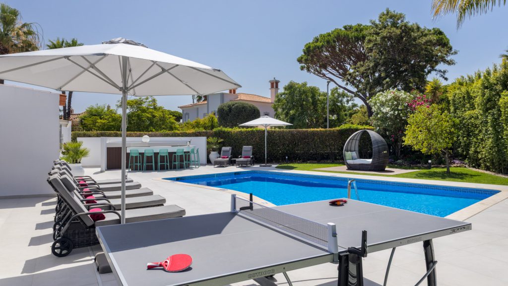 Comfortable outdoor lounge area with cushioned sofas by the private pool