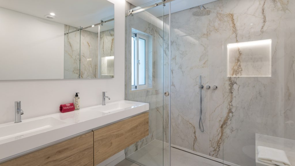 Contemporary guest bathroom with walk-in shower and stone finishes